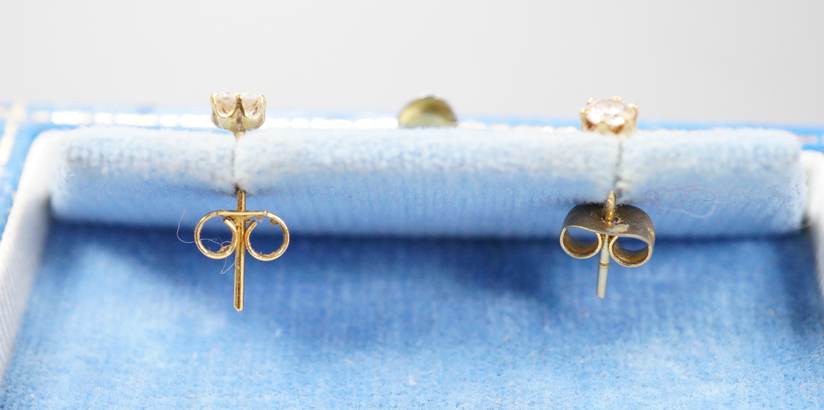 A pair of 750 yellow metal and solitaire diamond set ear studs, gross weight 0.9 grams